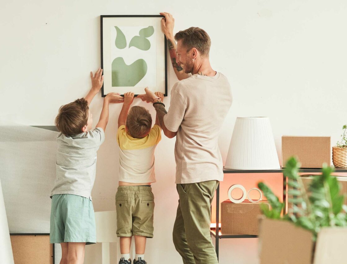 Family hanging a picture